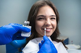 Woman smiling as dentist preps for veneers in River Ridge