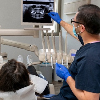 Dentist showing patient the results of her X-rays