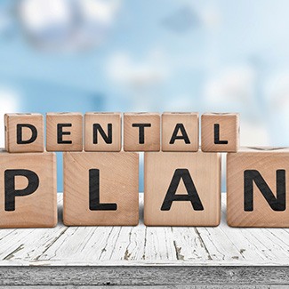 Wood blocks with letters spelling “Dental Plan”