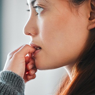 Closeup of woman biting her nails