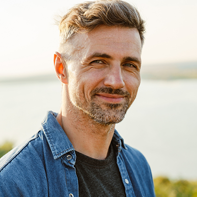Man in denim jacket smiling