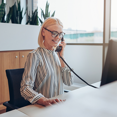 Woman with glasses talking on phone