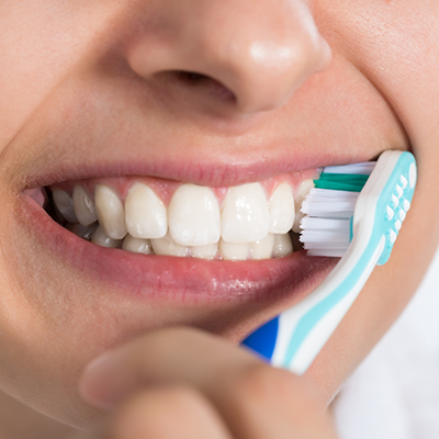 Close up of person brushing their teeth