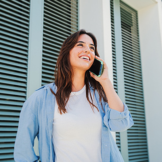 Woman in denim jacket talking on phone