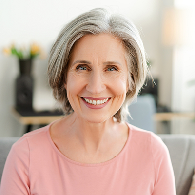 Senior woman in pink shirt smiling