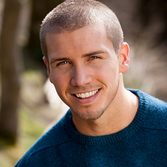 Man in blue shirt smiling