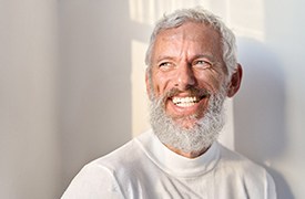 Senior man with a beard and white shirt
