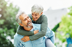 Senior man and woman outside laughing and smiling