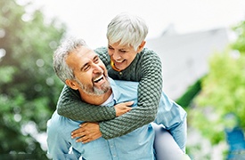 Senior man and woman outside laughing and smiling