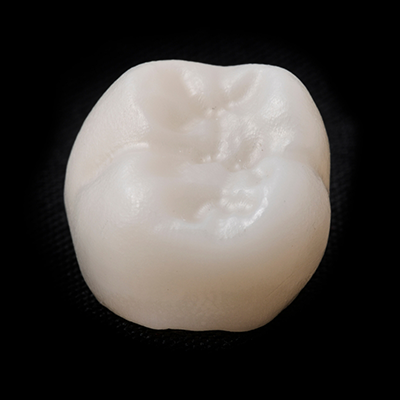 Close up of dental crown with black background