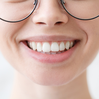 Close-up of smiling patient with glasses