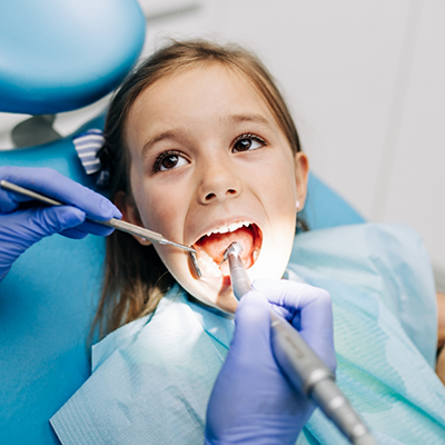 Little girl having teeth cleaned by children's dentist in River Ridge