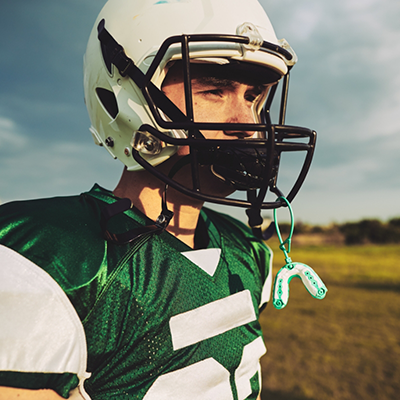 Young boy with football helmet and mouthguard