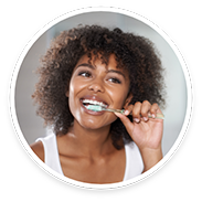 Woman in white shirt brushing her teeth