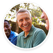 Man in green shirt laughing and smiling outside