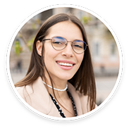 Woman with glasses and necklace smiling