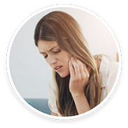Woman with long hair with pain in jaw