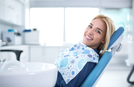 A female patient smiling while waiting to have her teeth checked by a dentist near Kenner, LA