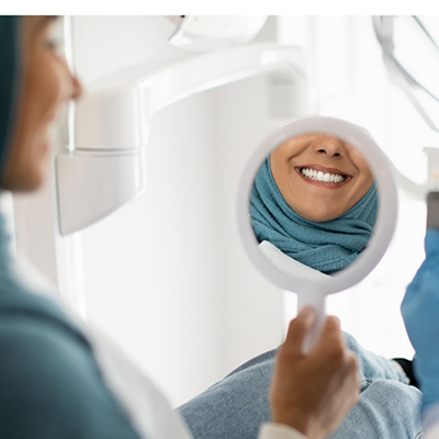 Female patient checking her smile with veneers