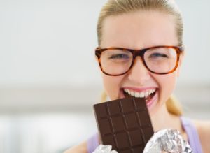 woman smiling eating candy