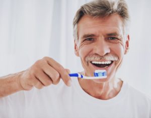older man about to brush his teeth
