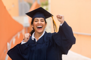 a student smiling during a graduation ceremony 