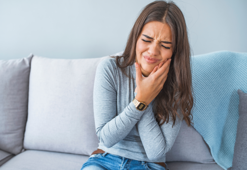 Woman holding jaw in pain